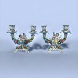 A pair of Sitzendorf porcelain two-light candelabra, of scrolled flower-encrusted design and modeled