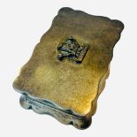 A silver and silver gilt serpentine-rectangular pill box with hinged cover, top mounted with the