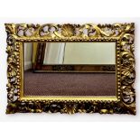 An early 19th century rococo revival gitl-wood and gesso rectangular wall mirror, with pierced