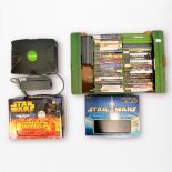 An original Xbox console, with controller, power brick, and AV cables, in a Gamester satchel carry