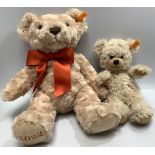A 2022 Steiff bear with tied ribbon scarf, 35cm, and a smaller Steiff bear with bean-bag filling,