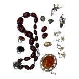 A set of dark amber beads, together with various silver brooches and rings etc.