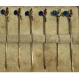 A set of six 9ct gold cocktail sticks surmounted with a double sided enamelled cockerel, each marked