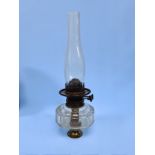 A Victorian clear glass oil lamp by Williams & Bach of London, 42cm high including glass chimney