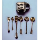 A small collection of assorted silver items comprising an ornately worked and pierced mustard by