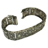 A 15ct and 18ct white gold Art Deco bracelet, 20 x articulated rectangular panels, set with