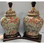 A pair of Oriental brightly painted lamps, modelled as converted ginger jars and cover, decorated