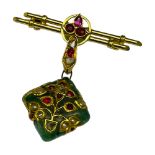 A yellow gold bar and jade pendant brooch, set with 3 x Burmese rubies to the centre of the double