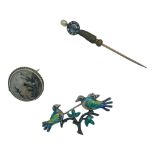 Three various brooches, including a silver enamel bird brooch, a round moss-agate brooch, and a