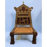 A 20th Century Indian rosewood low folding chair, carved wood, brass and metal overlaid decoration