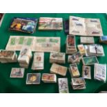 A large quantity of cigarette cards and some tea cards (see 1st photo) as well as loose stamps and