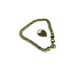 A 9ct yellow gold double and roller ball link bracelet, with padlock charm, weighs 5.8 grams.