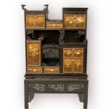 A Japanese Meji period ebonised Shodona cabinet, the multiple cupboards with Shibiyama decoration to