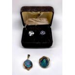 A 9ct gold ring and pendant set, each with an oval modern opal triplet in a four claw setting,