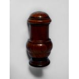 An antique treen caster, yew or fruitwood, of baluster form, with rotating grinder, raised on turned