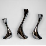 A set of three graduated contemporary stainless steel Georg Jensen Cobra candlesticks, with