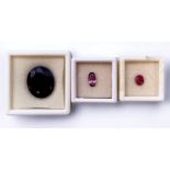 Three losse natural gemstones comprising a large oval faceted opaque blue Sapphire, 20.14mm x 16.