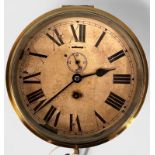 A ship’s brass cased bulkhead clock with white enamel dial and black Roman numerals and subsidiary