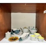 A collection of assorted Poole pottery tea and dinner wares, including two teapots, cups, saucers,