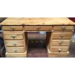 A stripped pine twin pedestal desk, with central frieze drawers and two banks of short drawers. (af)