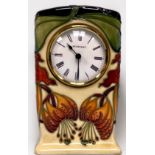 A Moorcroft Pottery ‘Anna Lily’ pattern mantel clock, design by Nicola Slaney, 1998, marks to