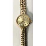 A ladies 9ct gold Omega wristwatch, the circular silvered dial with applied gold batons denoting
