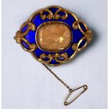 A Victorian pinchbeck and blue guilloche enamel mourning brooch, with central section displaying a