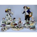 Six assorted Sitzendorf porcelain figures comprising a pair of fruit pickers with baskets and a