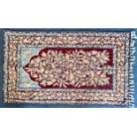 A handmade Crewel work fringed prayer rug, worked with birds and tree of life, 150x88cm