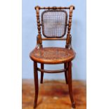 Two dining chairs, including a bentwood and bergere caned example, circular seat and stretcher, with