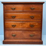An Edwardian walnut chest of two short, over three long, graduated drawers with decorative brass