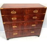 A 20th century, two-section flame mahogany campaign style chest, the top section with two short over
