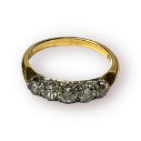 An 18ct yellow gold ring, claw set with five graduated Victorian cut diamonds, total estimated