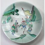 A Chinese Kangxi period porcelain dish, painted in Wucai enamels depicting a scene with six