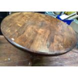 A Victorian rosewood circular tilt-top dining table, raised on inverted turned column to disc