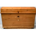 A large late 19th/early 20th century continental pine dome top trunk, the lockable dome top
