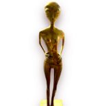 A cast brass firgure of a standing alien, signed and dated 'Bunter 1996' 95cm high