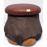A taxidermy elephants foot-stool with brown vinyl stuff-over seat