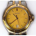 A gents bi-colour stainless steel Gucci 9040M quartz wristwatch, the gold dial with gilt batons