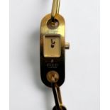 A ladies gold-plated Gucci quartz wristwatch, model 6100L, with square gilt dial, on chain bracelet,