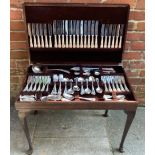 A mahogany side table with hinged top to reveal twelve-setting canteen of Sheffield silver-plated