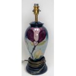 A Moorcroft 'purple magnolia' baluster table lamp, with wooden base, 30cm high