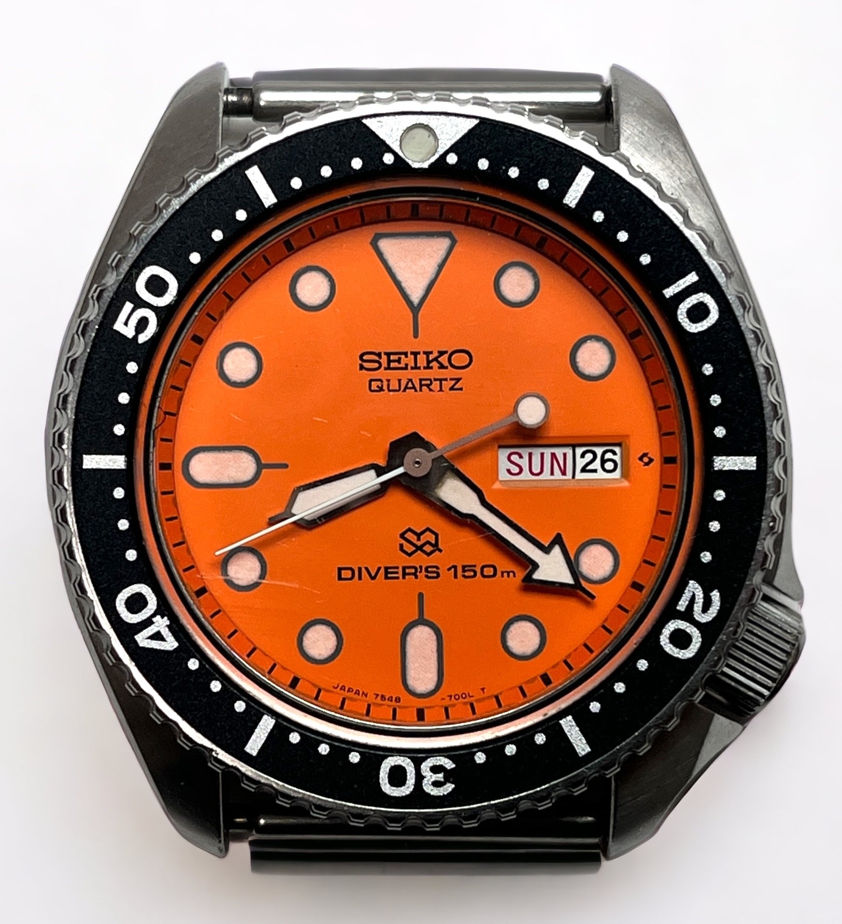 A vintage Seiko Quartz SQ Divers 150m stainless steel wristwatch, the orange enamel dial with dot
