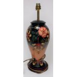 A Moorcroft pottery table lamp of inverted baluster form and decorated in the Hibiscus Moon pattern,