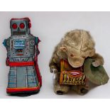 Two vintage tinplate toys comprising, a West German clockwork tinplate Monkey playing a hypnotic