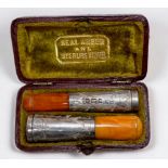 Two graduated silver and amber cheroot holders, hallmarked Birmingham, 1900, in original two
