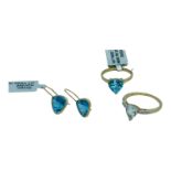 A 9ct yellow gold dress ring, claw set with a blue faceted stone, and matching earrings, together