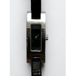 A ladies stainless steel Gucci 3900L wristwatch, the black enamel dial with branding, on slim