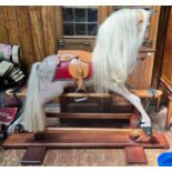 A 20th century rocking horse, painted in grey with black and white detailing, with blonde mane and