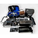 A collection of eleven cameras including Pentacon Praktica LLC in fitted leather carry case,